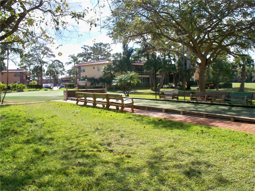 1913 Southwest Palm City Road, Unit 7B Stuart, FL 34994 - Photo 33 of 37 a view of a swimming pool with a yard