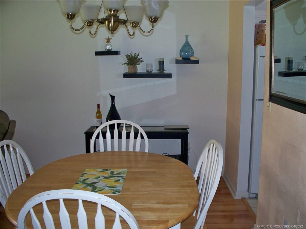 1913 Southwest Palm City Road, Unit 7B Stuart, FL 34994 - Photo 9 of 37 a view of a dining room with furniture