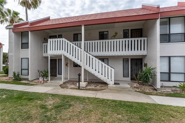 a view of a house with backyard and porch