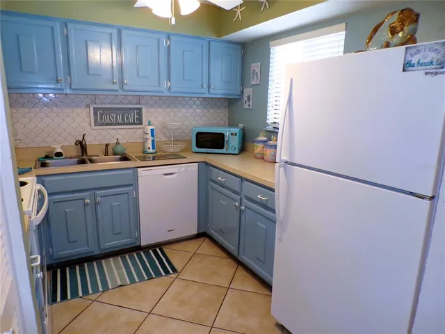 a kitchen with stainless steel appliances granite countertop a refrigerator sink and cabinets