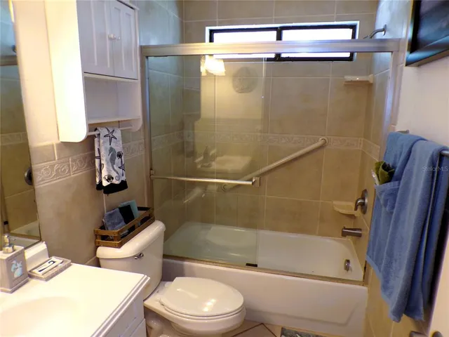 a bathroom with a shower a toilet and sink