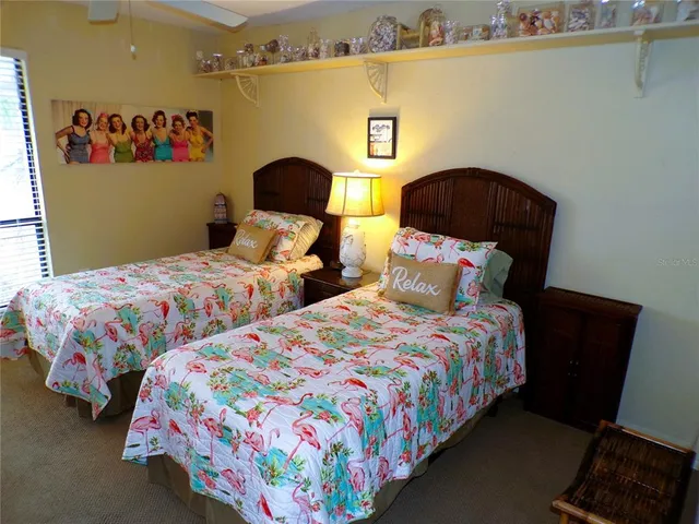 a bedroom with two beds and painting on the wall