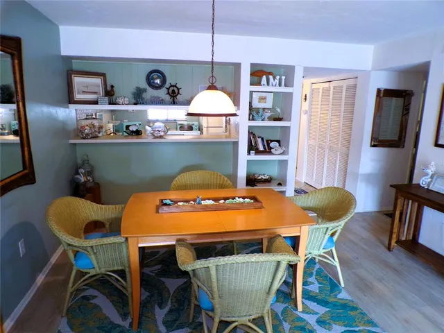 a dining room with furniture and wooden floor