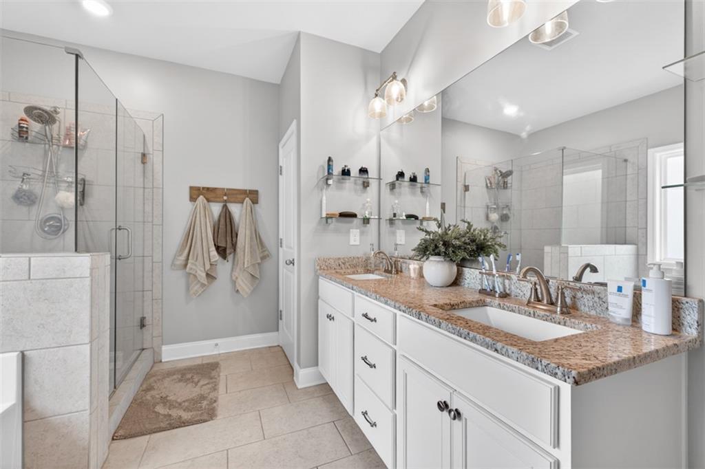 163 Hewett Road Pendergrass, GA 30567 - Photo 46 of 82 a bathroom with a granite countertop sink a shower and a mirror