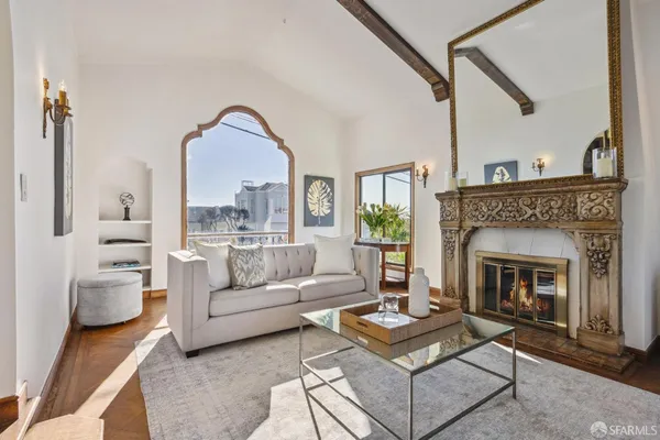 a living room with furniture and a fireplace