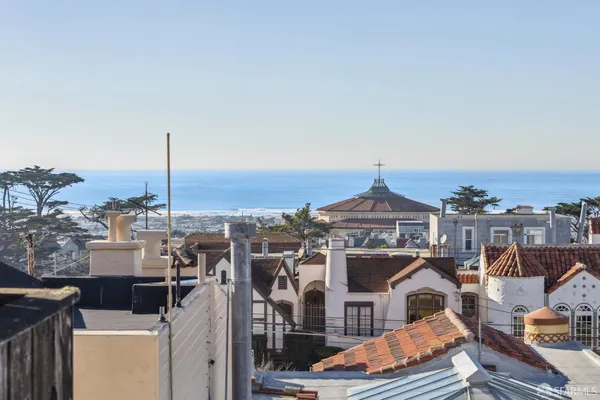 a front view of a residential apartment building with a city view