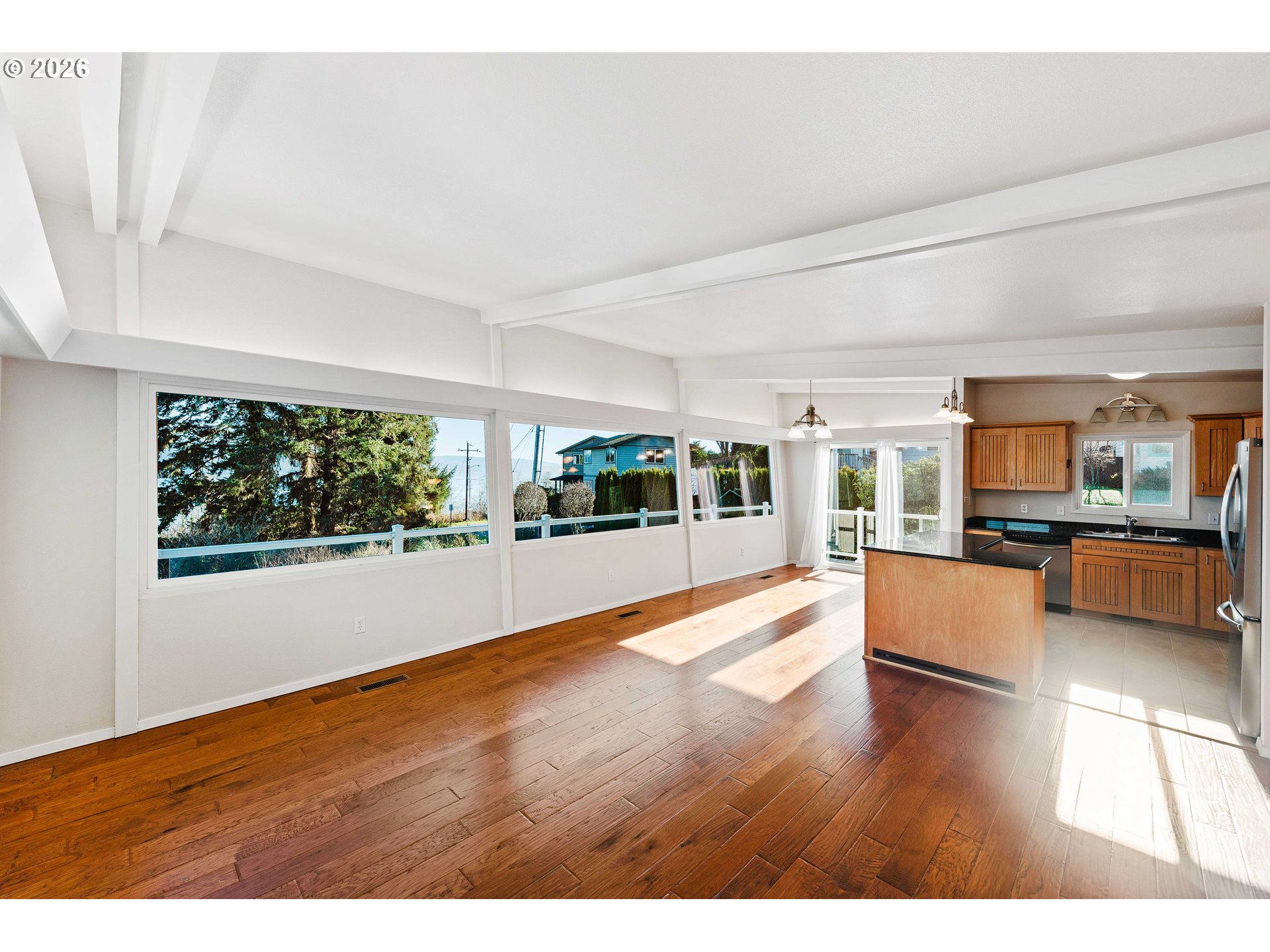451 Simpson Avenue North Bend, OR 97459 - Photo 16 of 41 a view of an empty room with wooden floor and a window