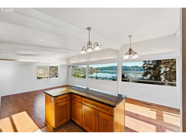 a kitchen with a sink and large windows