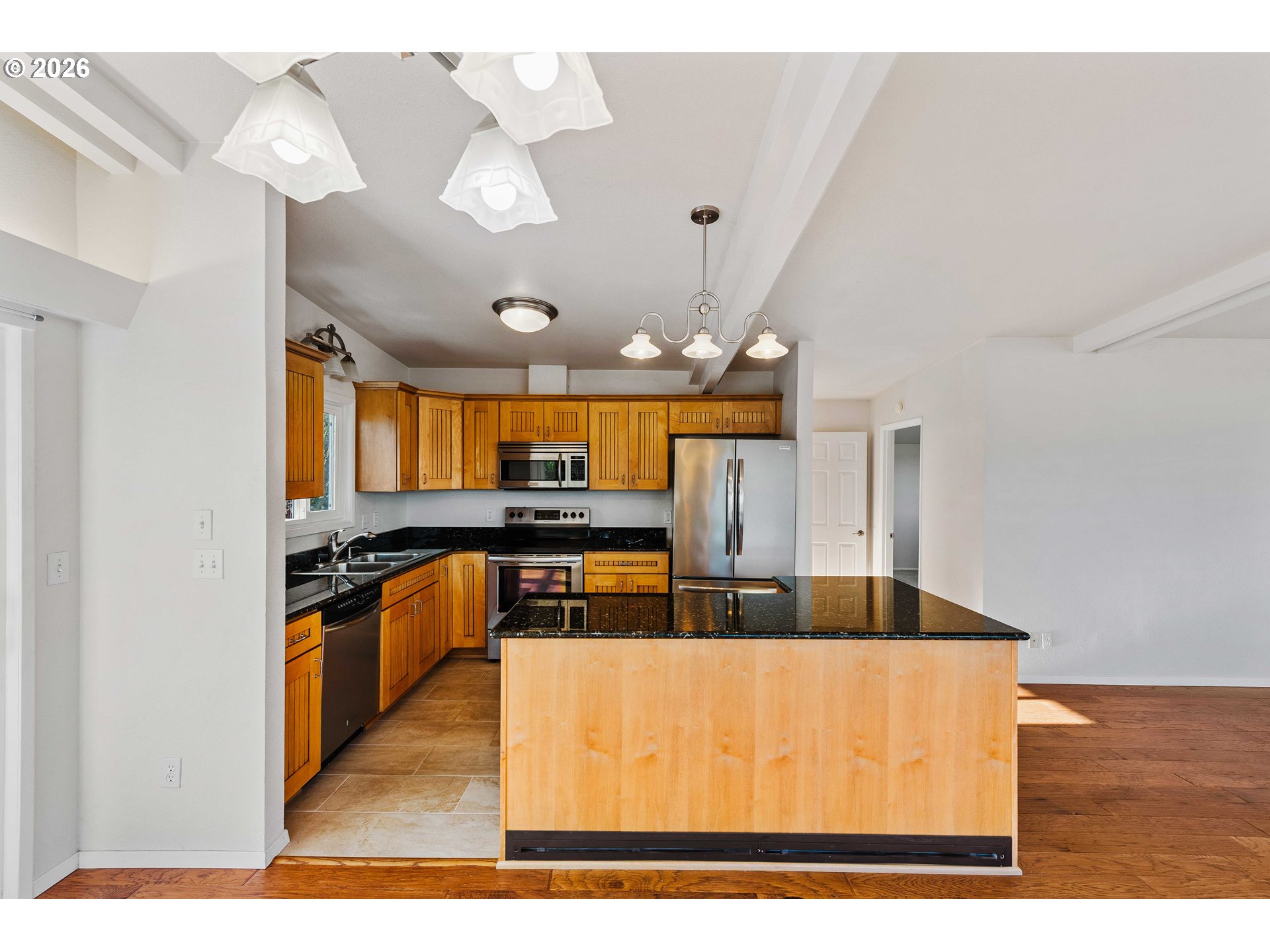 451 Simpson Avenue North Bend, OR 97459 - Photo 22 of 41 a kitchen with stainless steel appliances granite countertop a sink a stove top oven a counter space and cabinets