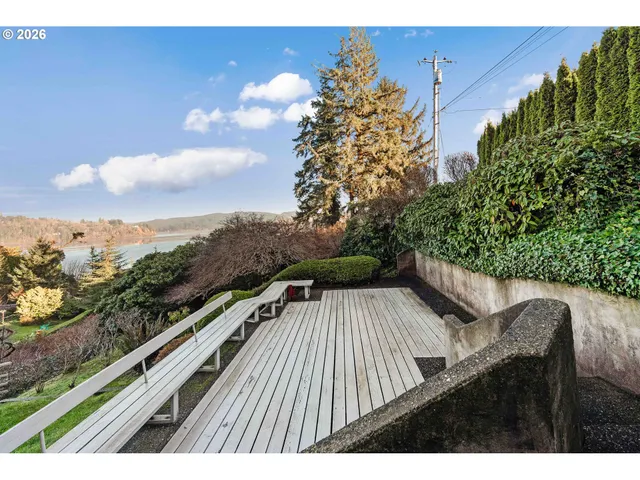a view of balcony with wooden floor and fence