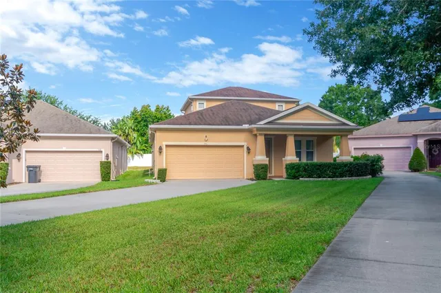 a front view of a house with a yard and garage