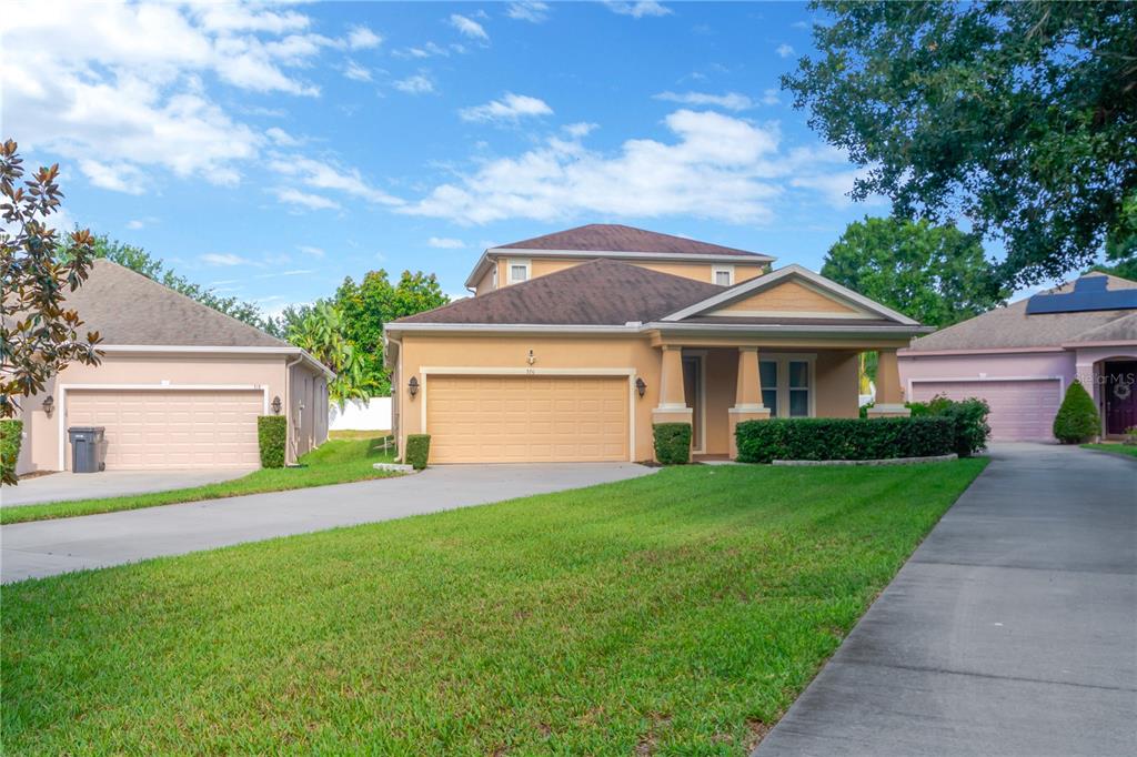 a front view of a house with a yard and garage