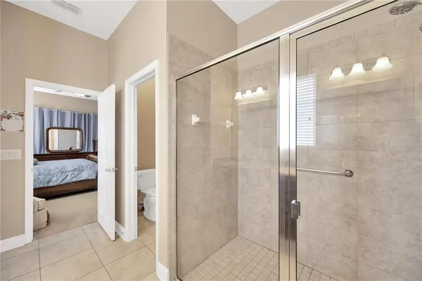 a bathroom with a glass shower door and a bathroom sink