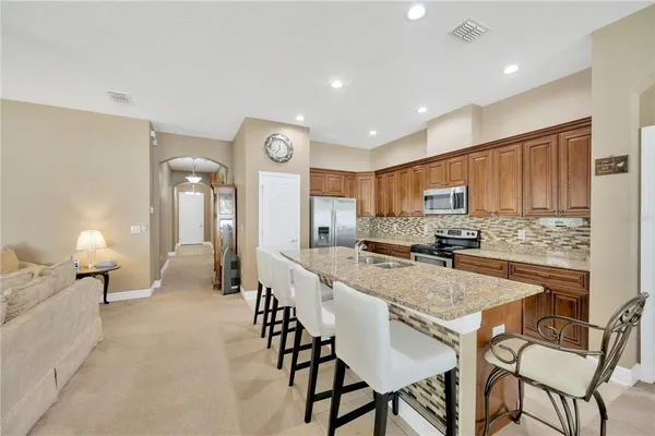 a large kitchen with a table and chairs