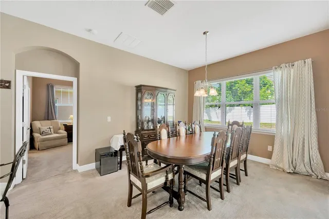 a view of a dining room with furniture window and outside view