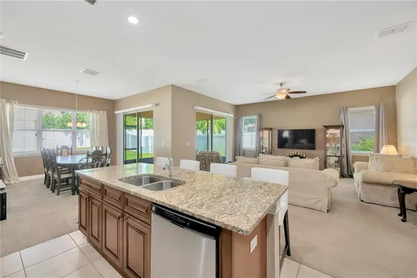 a view of kitchen island a sink and living room