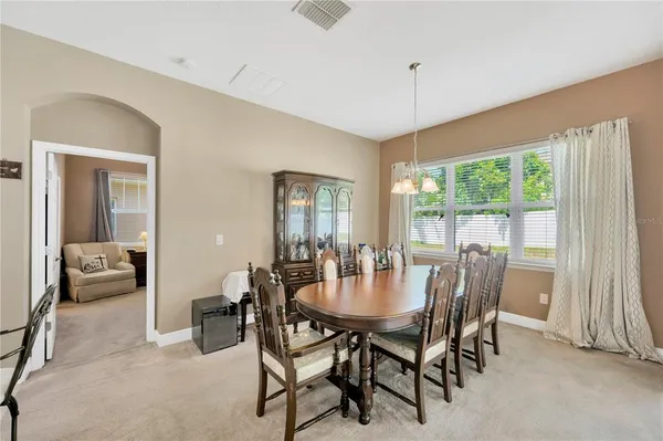 a view of a dining room with furniture window and outside view