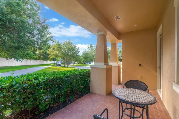 a view of a porch in front of a house with a yard