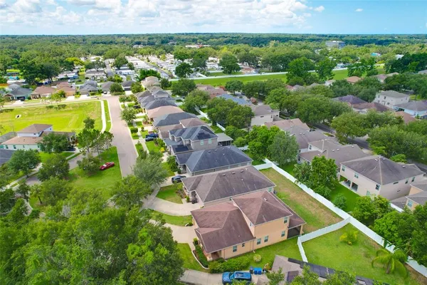 an aerial view of residential houses with outdoor space and river