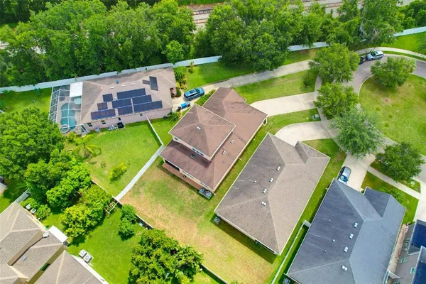 an aerial view of a house with a yard
