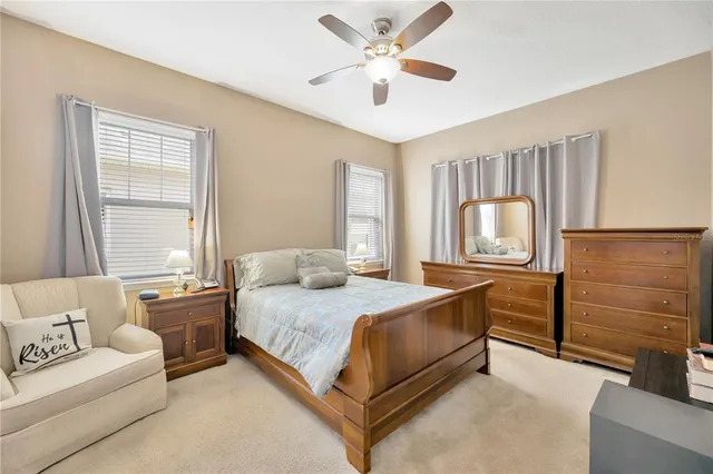 a bedroom with a bed dresser and wooden floor