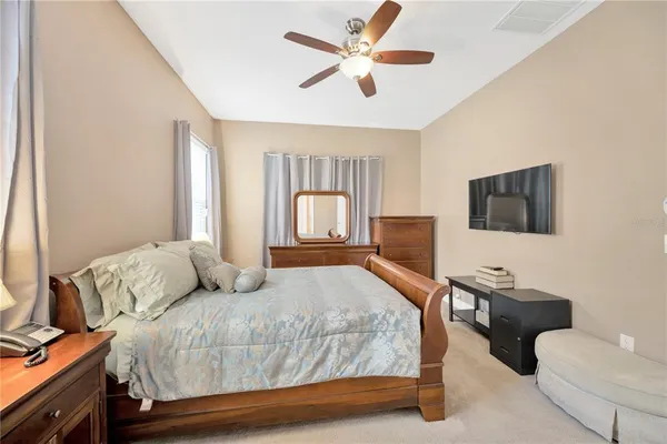 a bedroom with a large bed and a flat screen tv