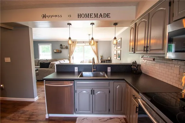 a kitchen with stainless steel appliances a sink stove and cabinets
