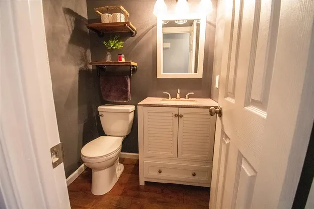 a bathroom with a toilet sink and mirror