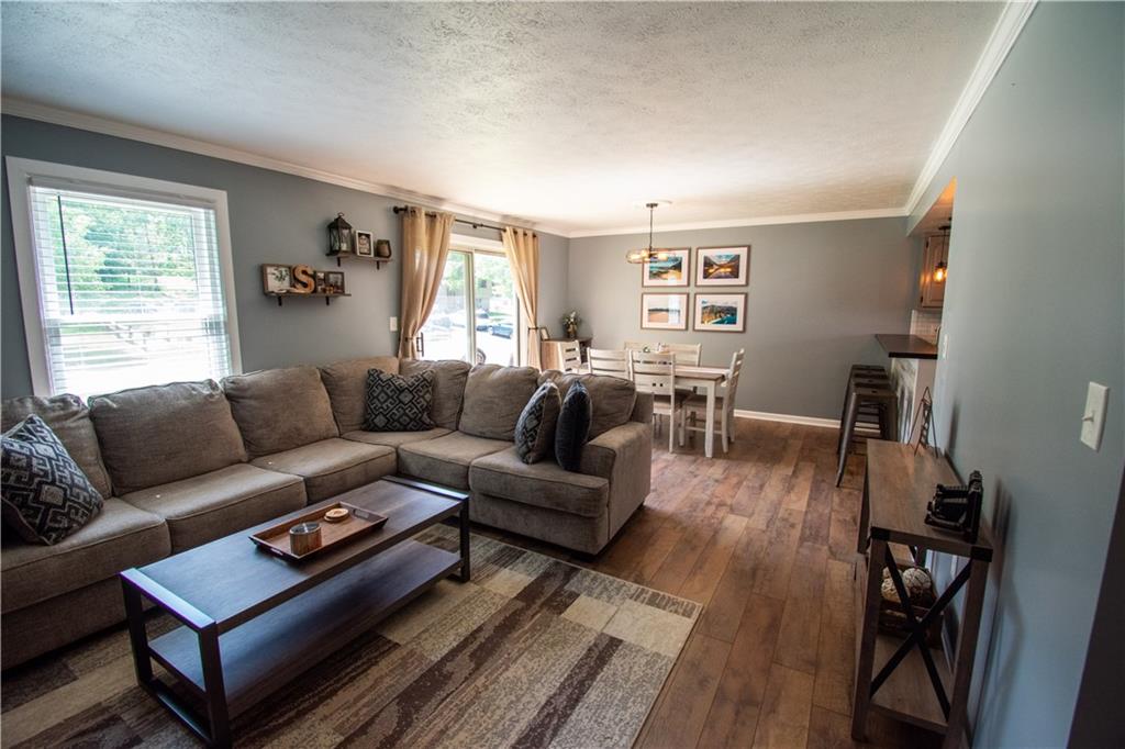 222 Carters Grove Drive Gibsonia, PA 15044 - Photo 2 of 27 a living room with furniture a wooden floor and a window
