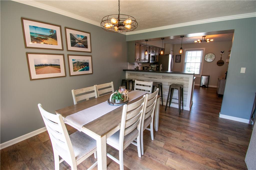222 Carters Grove Drive Gibsonia, PA 15044 - Photo 4 of 27 a view of a dining room with furniture a chandelier and wooden floor