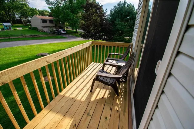 a view of balcony with wooden floor and outdoor seating