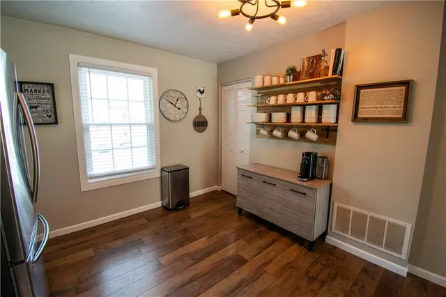a view of a hardwood floor and windows in a room
