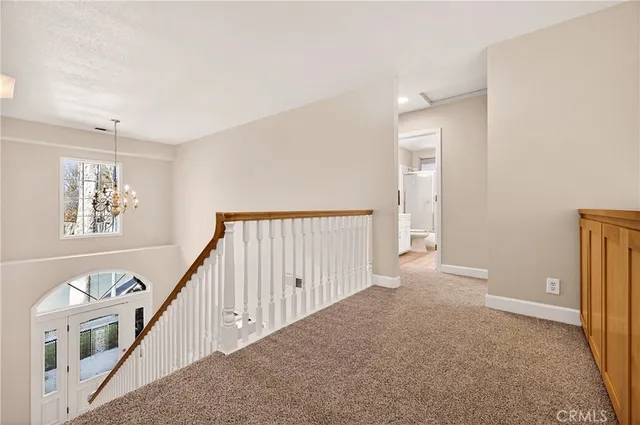 a backyard of a house with barbeque oven and a tree