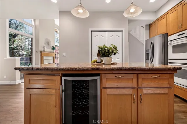 a kitchen with granite countertop a sink and cabinets
