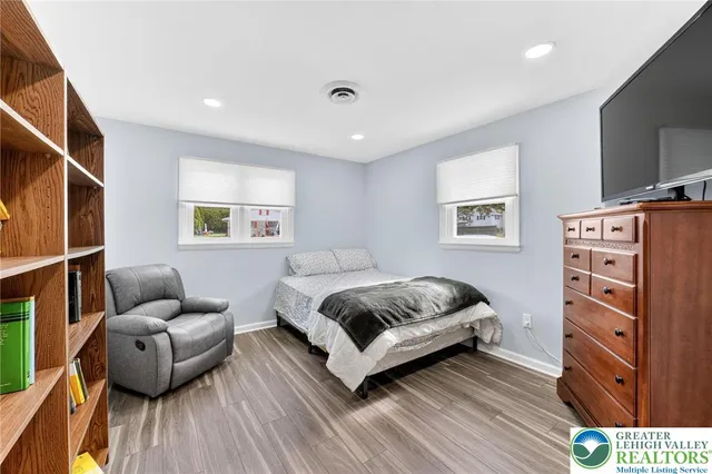 a bedroom with a bed and a couch