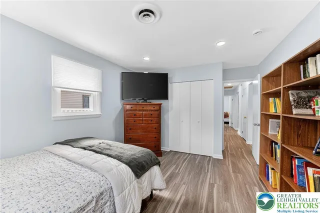 a bedroom with a bed and a book shelf