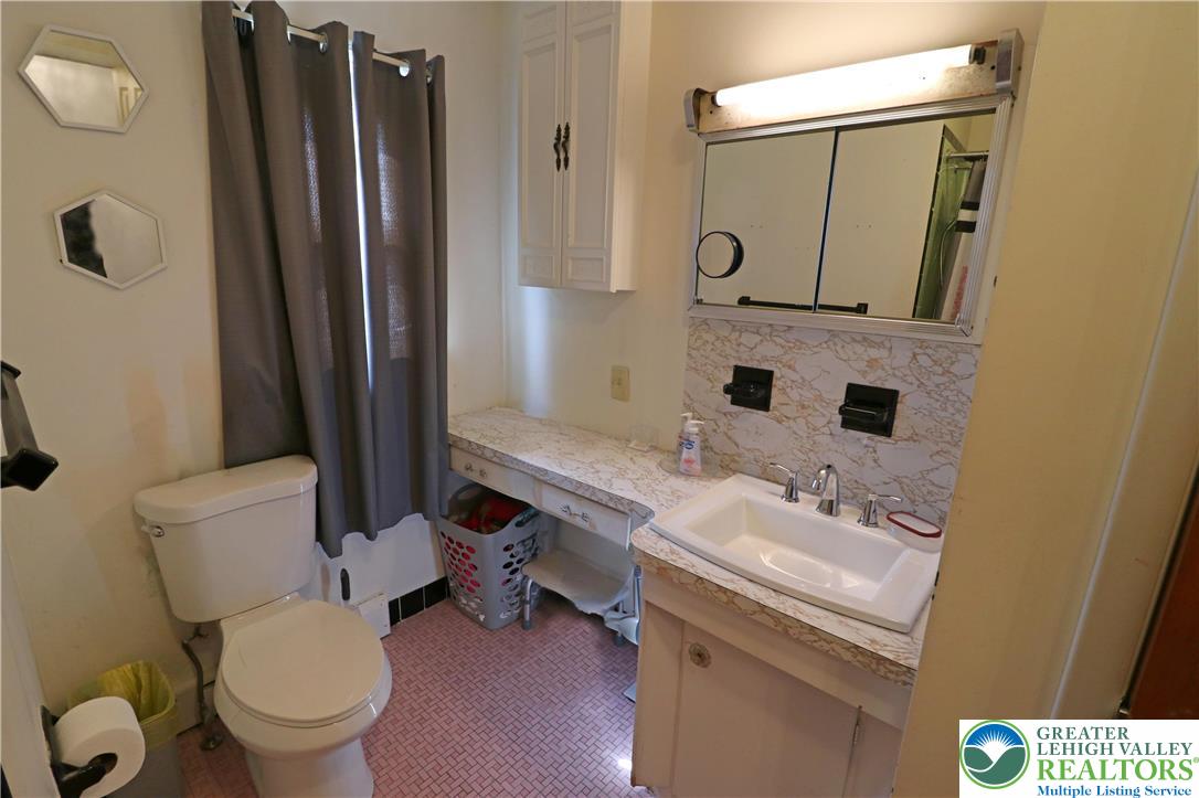 1022 Hilton Street Bethlehem, PA 18017 - Photo 14 of 35 a bathroom with a sink a toilet and a mirror