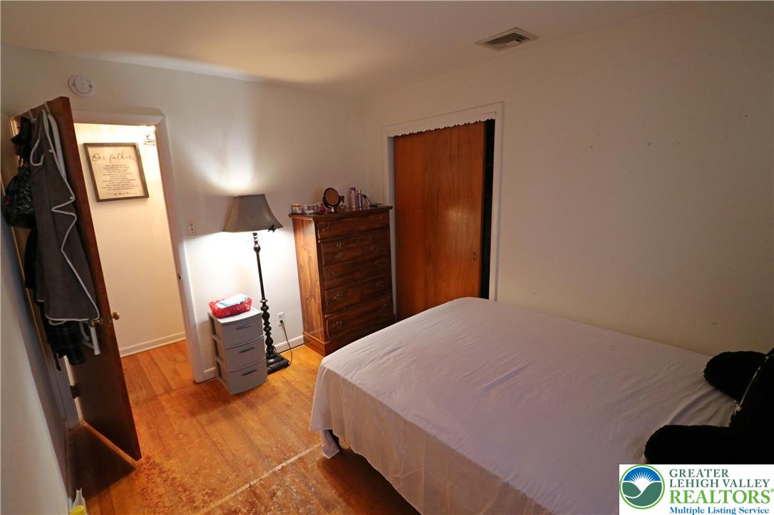 1022 Hilton Street Bethlehem, PA 18017 - Photo 17 of 35 a bedroom with a bed and a flat tv screen on dresser