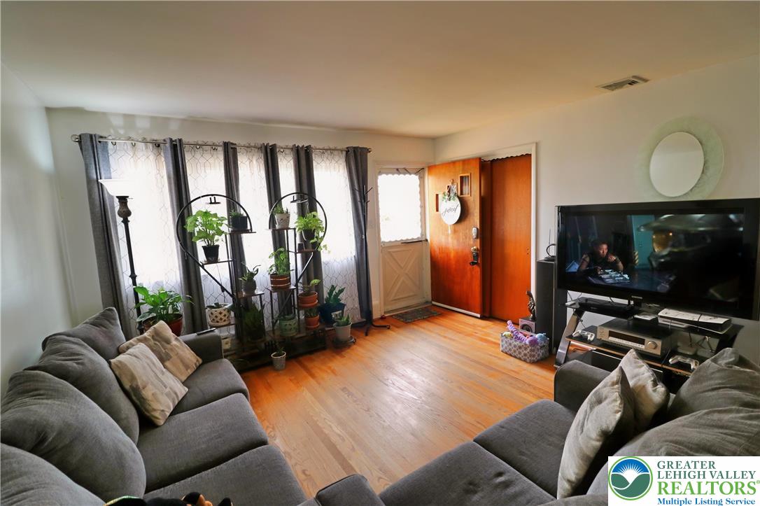 1022 Hilton Street Bethlehem, PA 18017 - Photo 5 of 35 a living room with furniture a flat screen tv and a large window