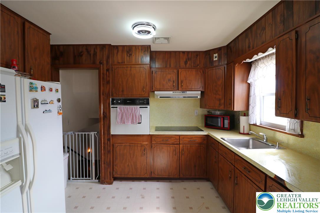 1022 Hilton Street Bethlehem, PA 18017 - Photo 8 of 35 a kitchen with a refrigerator sink and cabinets