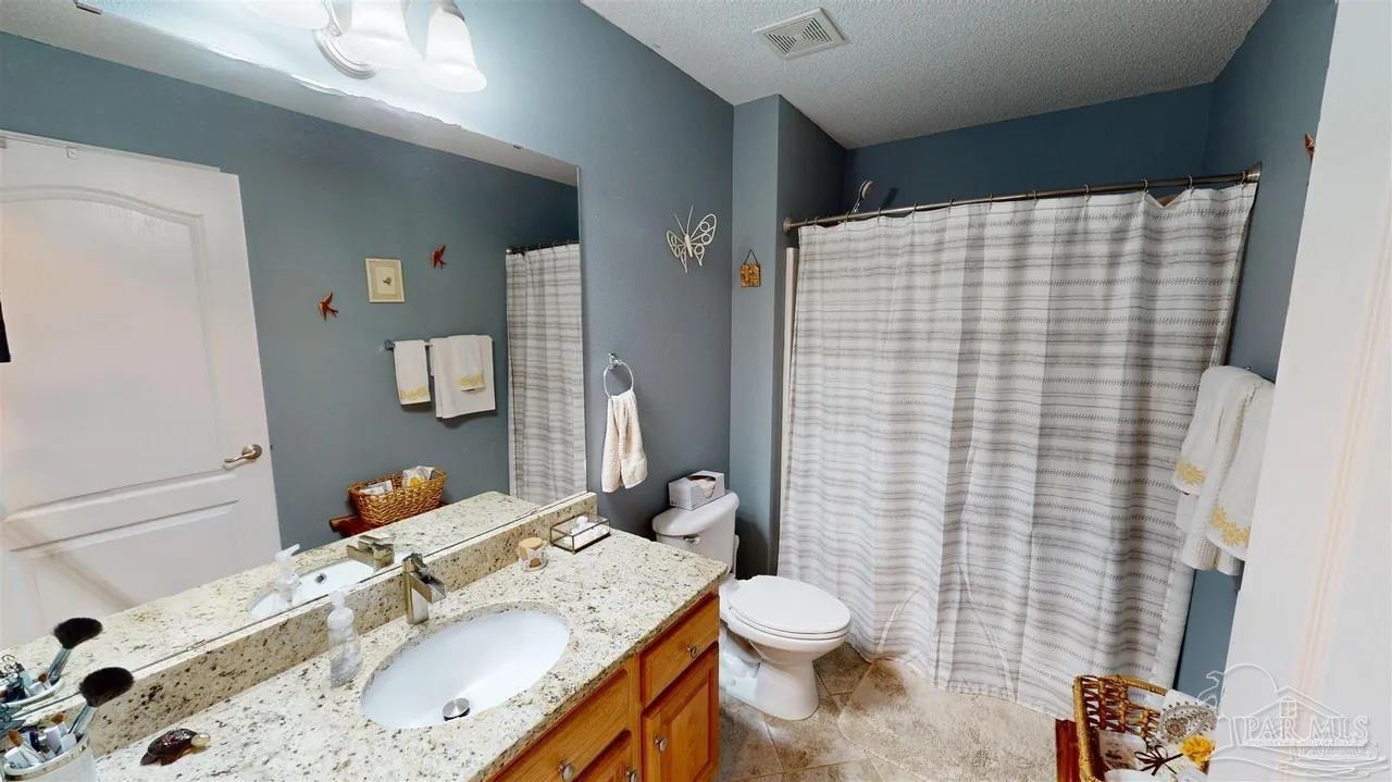 3055 Wallace Lake Road Pace, FL 32571 - Photo 31 of 33 a bathroom with a sink toilet and shower