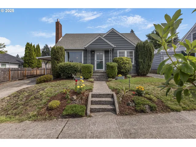 a front view of a house with a garden
