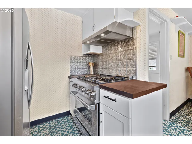 a kitchen with a stove and a refrigerator