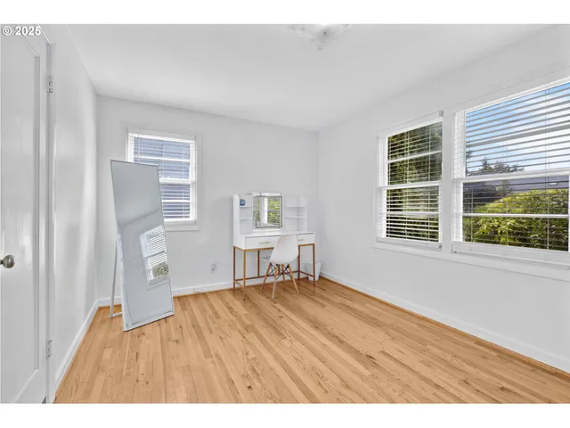 a big room with closet and wooden floor