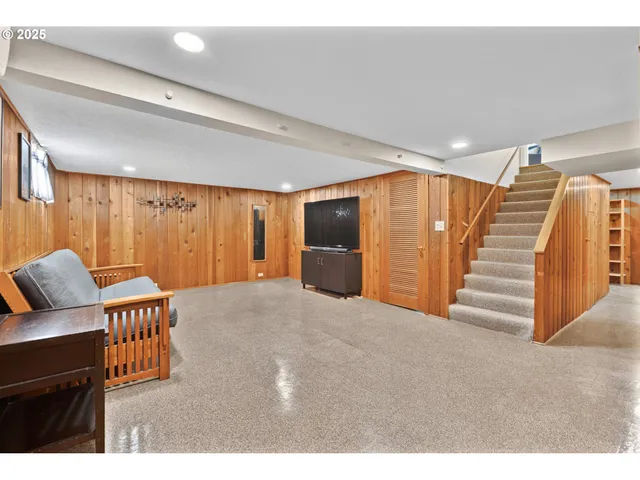a living room with furniture a ceiling fan and a window