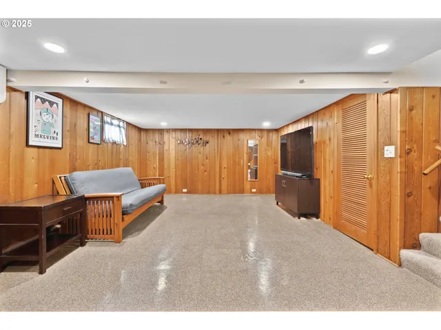a living room with a flat screen tv and a large window