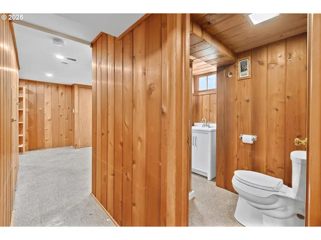 a bathroom with a toilet a sink and shower