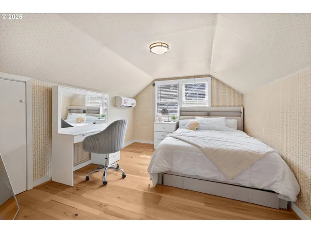 a bedroom with a bed a table and chair