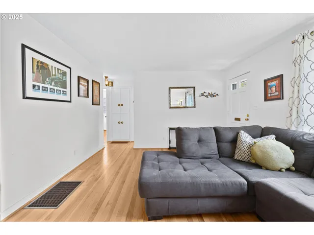 a living room with furniture and a wall painting