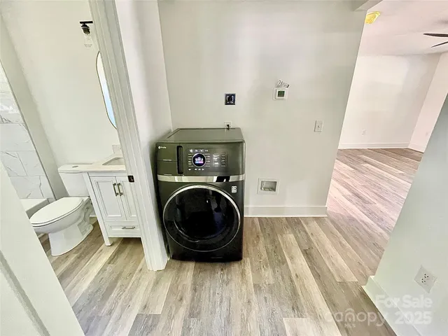 a view of a bedroom with washer and dryer